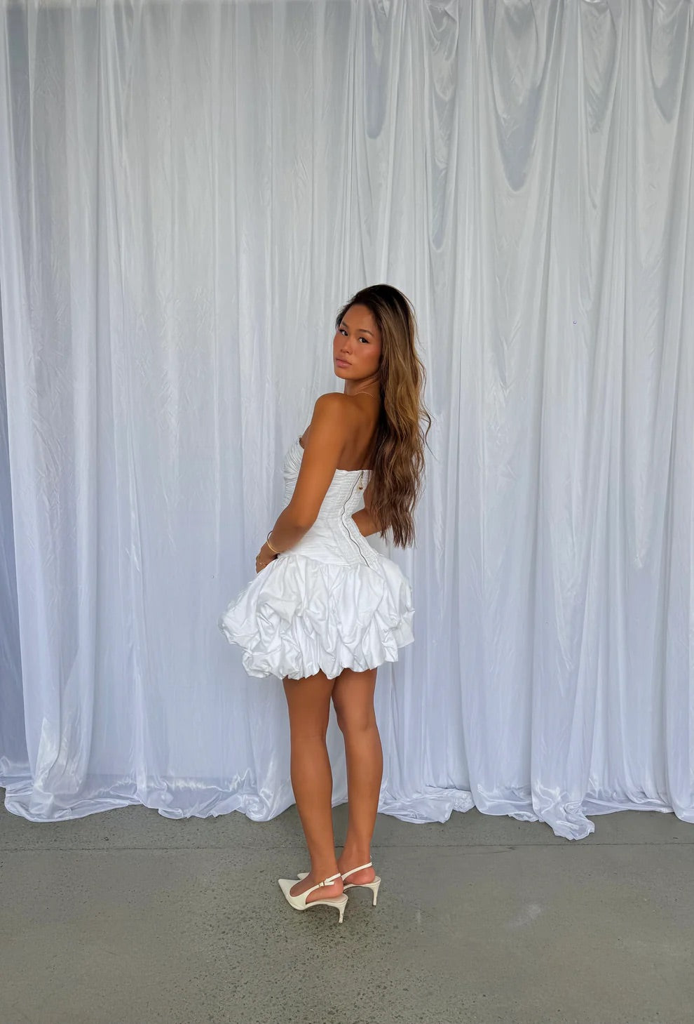 Violette Bubble Hem Mini in Ivory by Aje available for hire in Gold Coast, QLD
